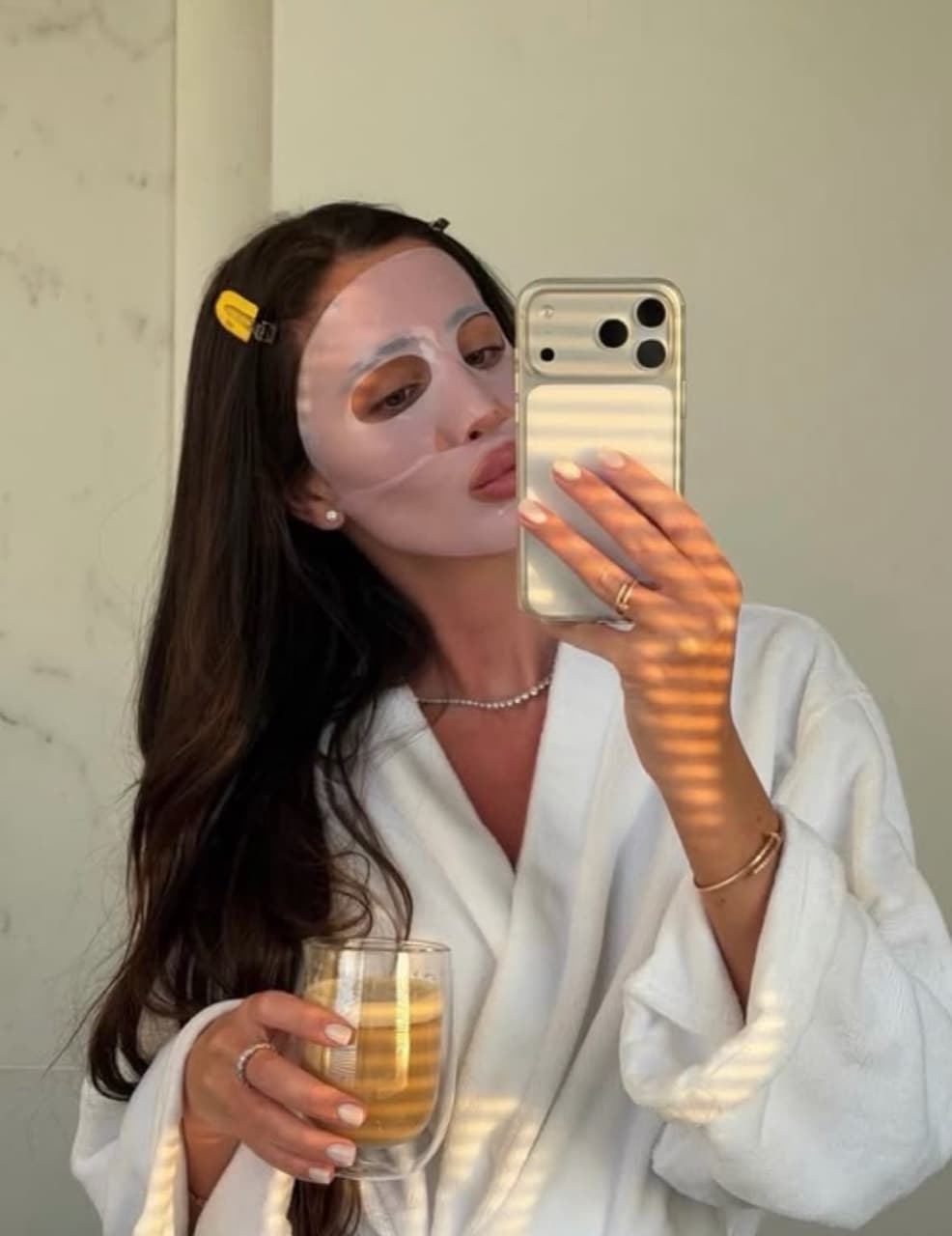 A relaxed sheet-mask routine in warm afternoon sunlight